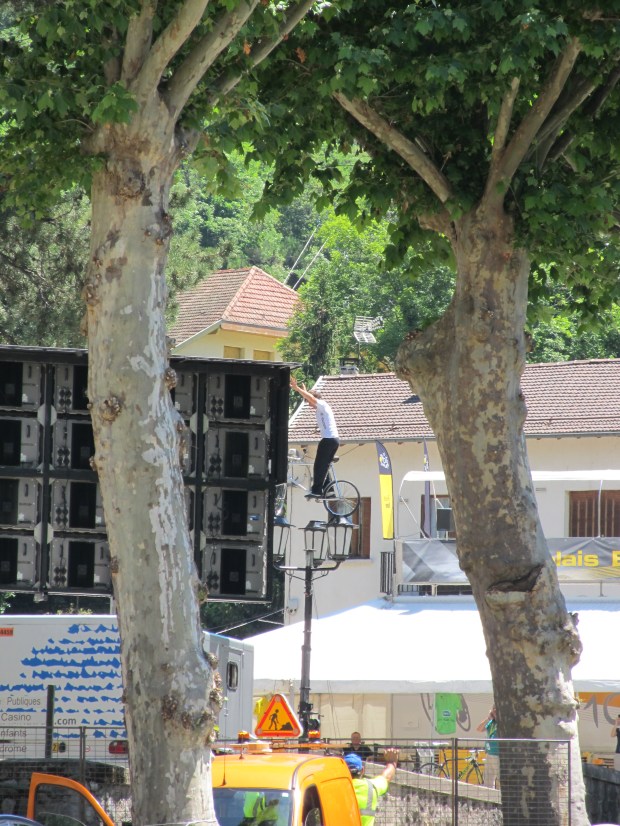 Some dude on a bike on top of a lamp-post. Yup we have the right town.